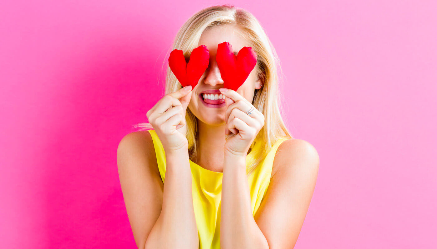 woman celebrating valentine's day with paper hearts